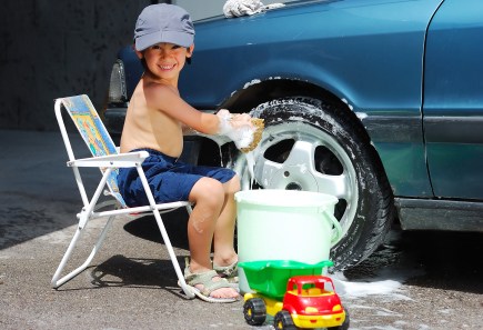 little boy washing car