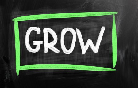 GROW with white chalk on blackboard