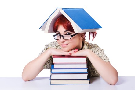 Girl with stack of books, one on her head