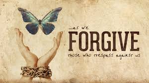 Open hands that are chained at the wrist and releasing a butterfly with quote - As we forgive those who trespass against us