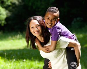 happy mother and son smiling together outdoors
