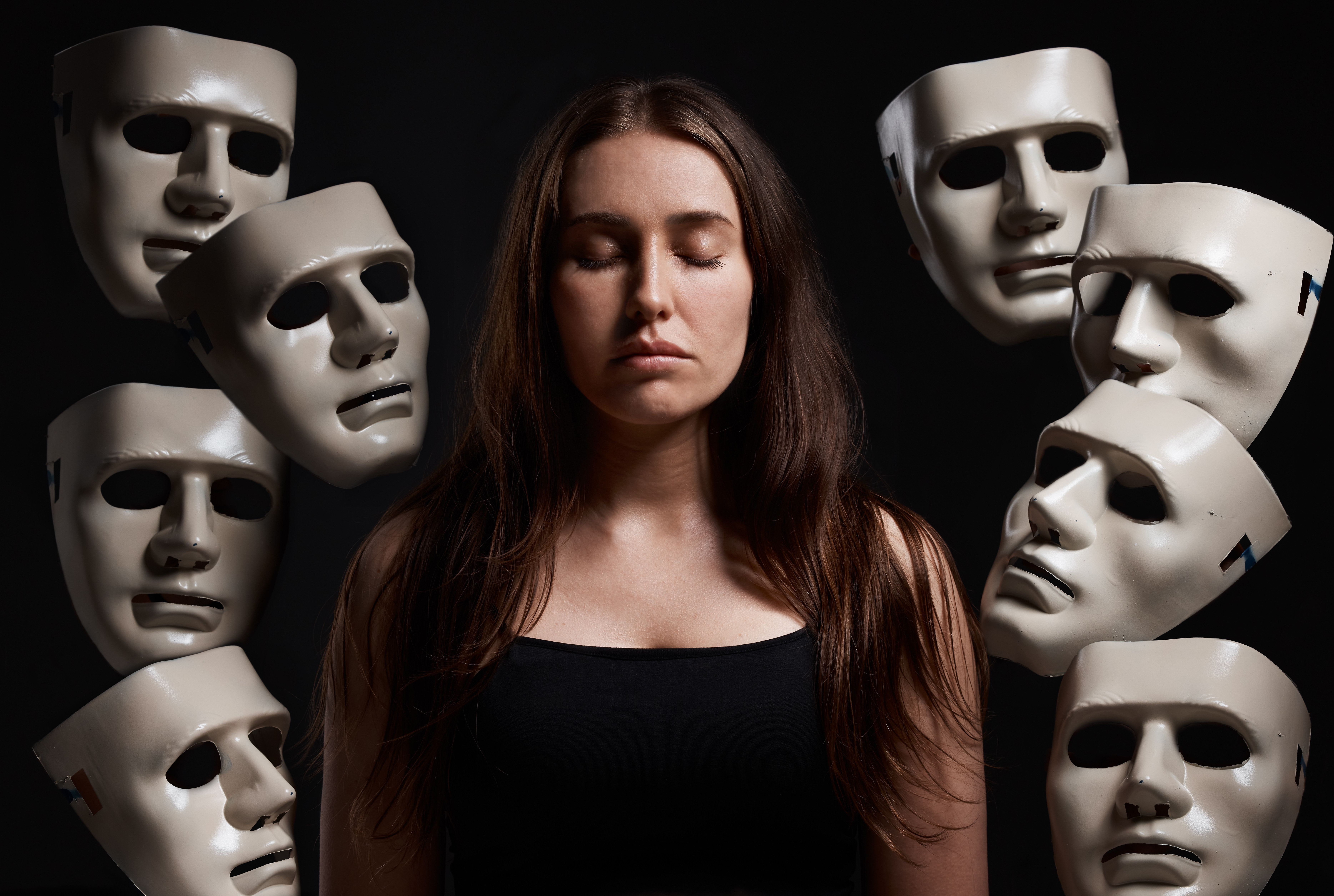 A woman surrounded by masks
